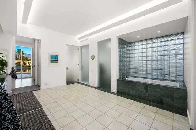 a bathroom with a granite countertop sink a mirror and a shower