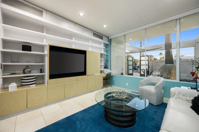 a living room with furniture lamp and rug