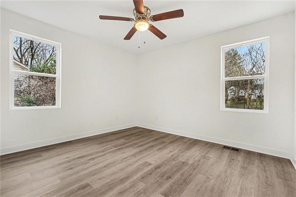 1684 Kenmore Street Southwest Atlanta, GA 30311 - Photo 12 of 30 wooden floor in an empty room with a window