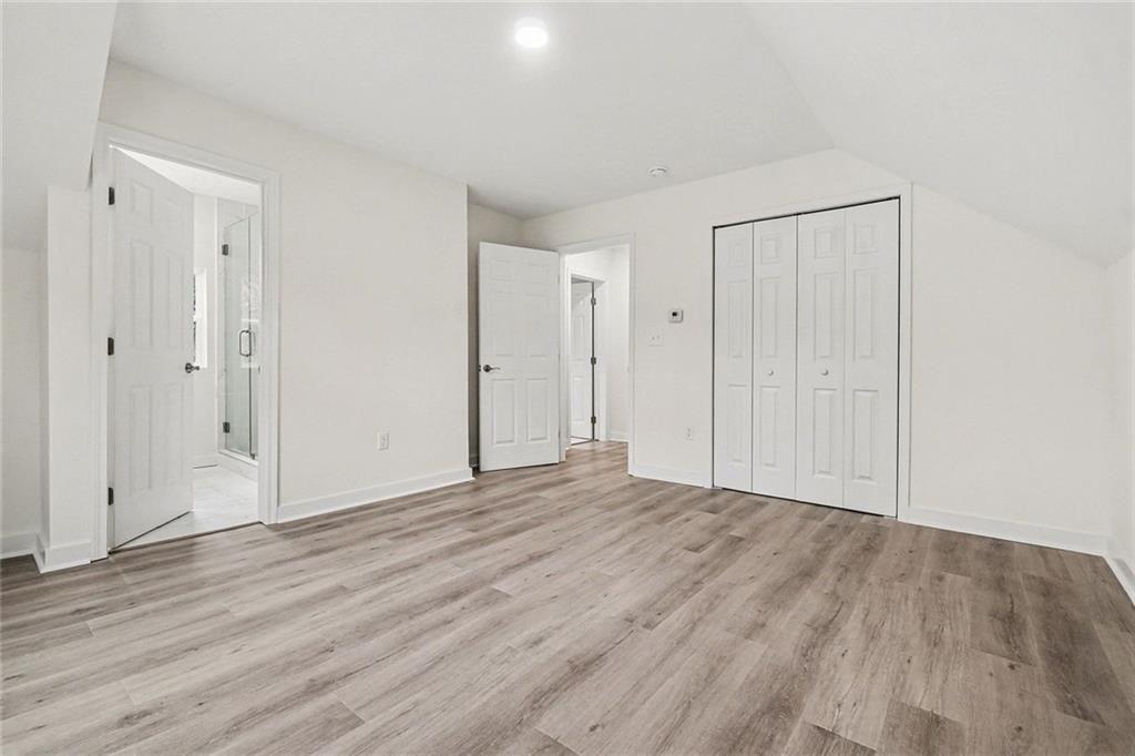 1684 Kenmore Street Southwest Atlanta, GA 30311 - Photo 22 of 30 a view of an empty room with wooden floor