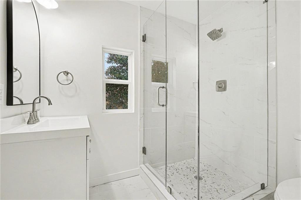 1684 Kenmore Street Southwest Atlanta, GA 30311 - Photo 24 of 30 a bathroom with a sink and a mirror