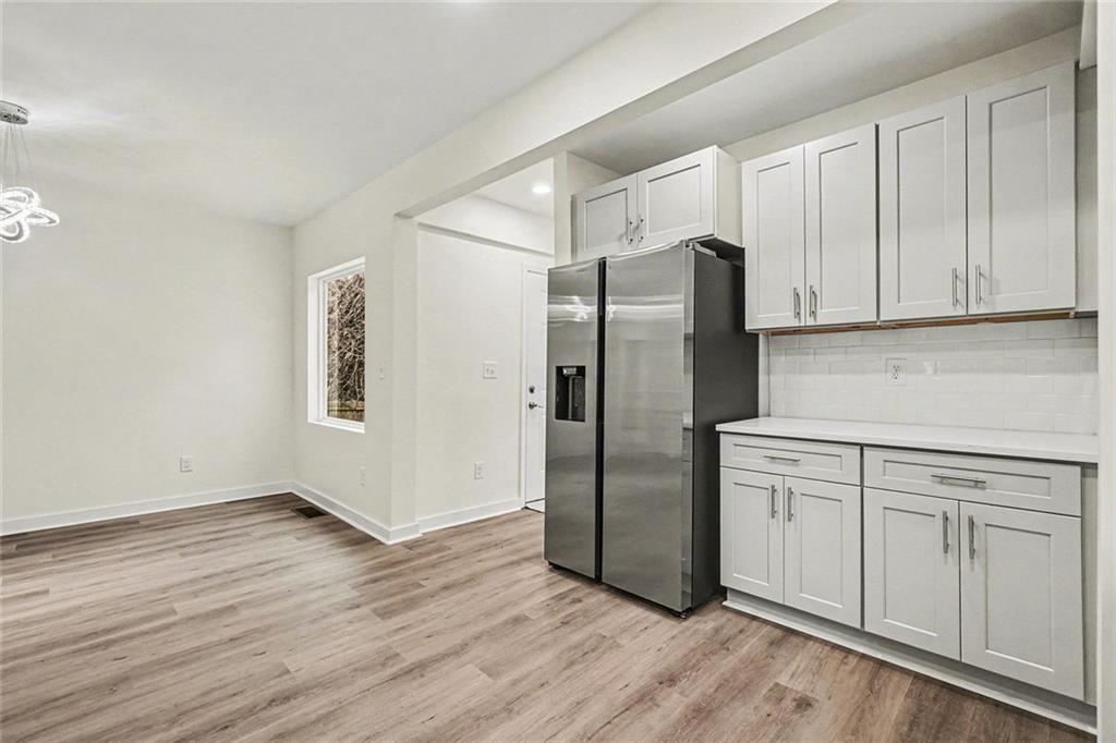 1684 Kenmore Street Southwest Atlanta, GA 30311 - Photo 28 of 30 a kitchen with stainless steel appliances granite countertop a refrigerator and a stove top oven