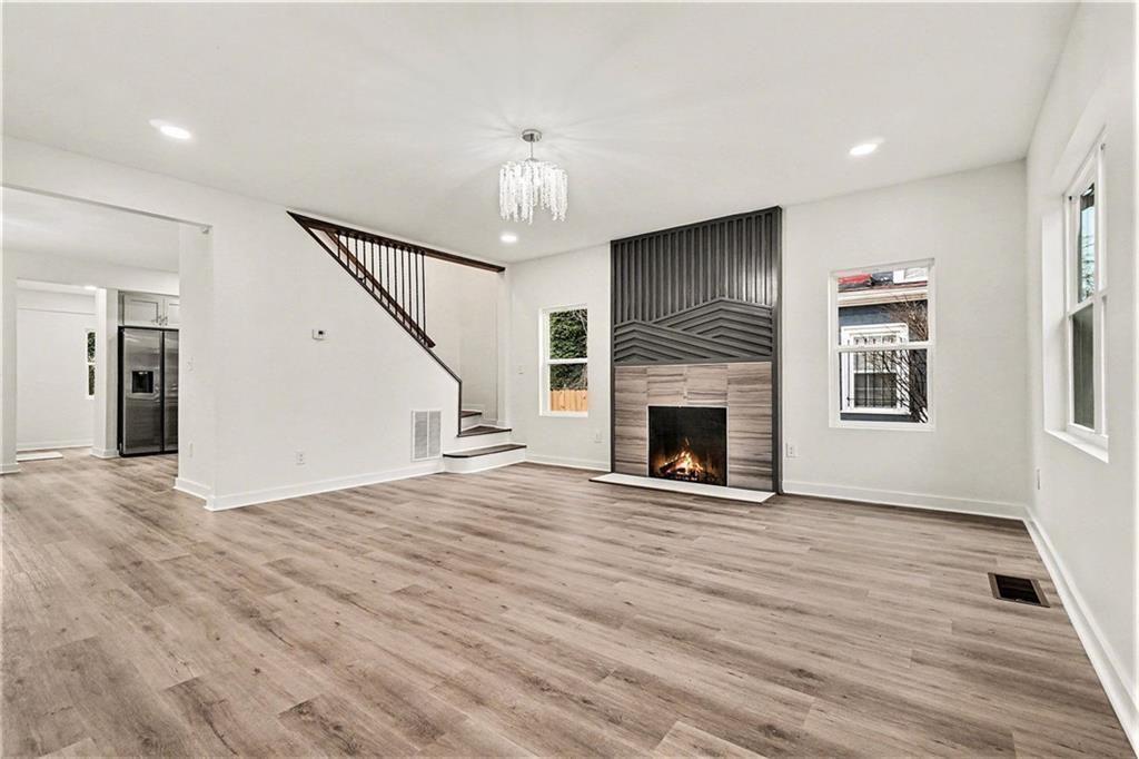 1684 Kenmore Street Southwest Atlanta, GA 30311 - Photo 6 of 30 a view of a livingroom with wooden floor fireplace and window