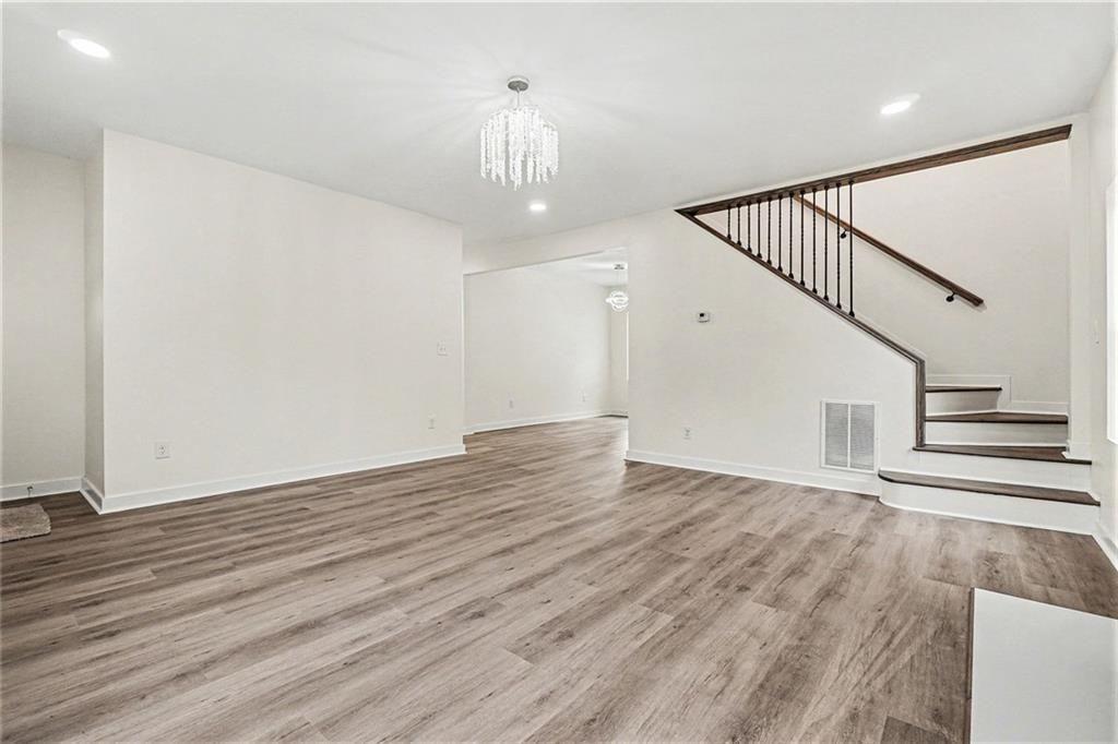 1684 Kenmore Street Southwest Atlanta, GA 30311 - Photo 8 of 30 a view of an empty room with wooden floor and stairs