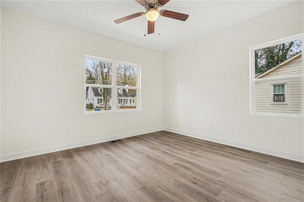 1684 Kenmore Street Southwest Atlanta, GA 30311 - Photo 9 of 30 a view of an empty room with wooden floor and a window