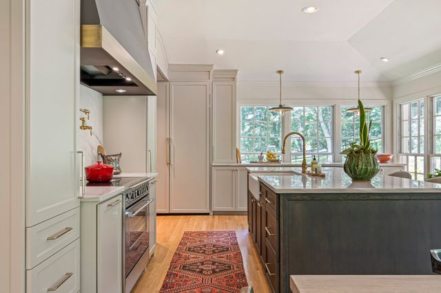 a view of a room with wooden floor and furniture