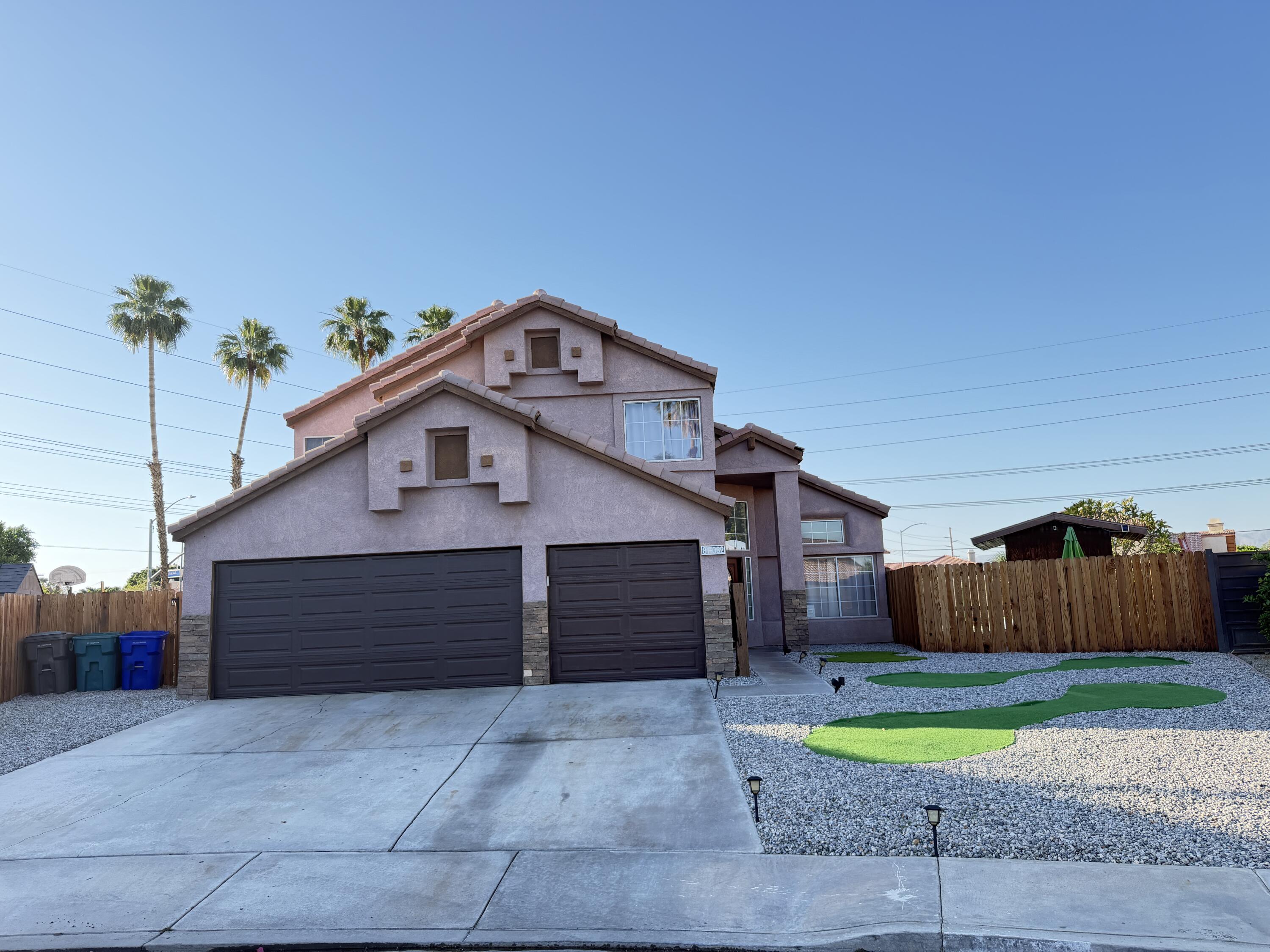 81032 Red Bluff Road Indio, CA 92201 - Photo 31 of 33 a front view of a house with a yard and garage