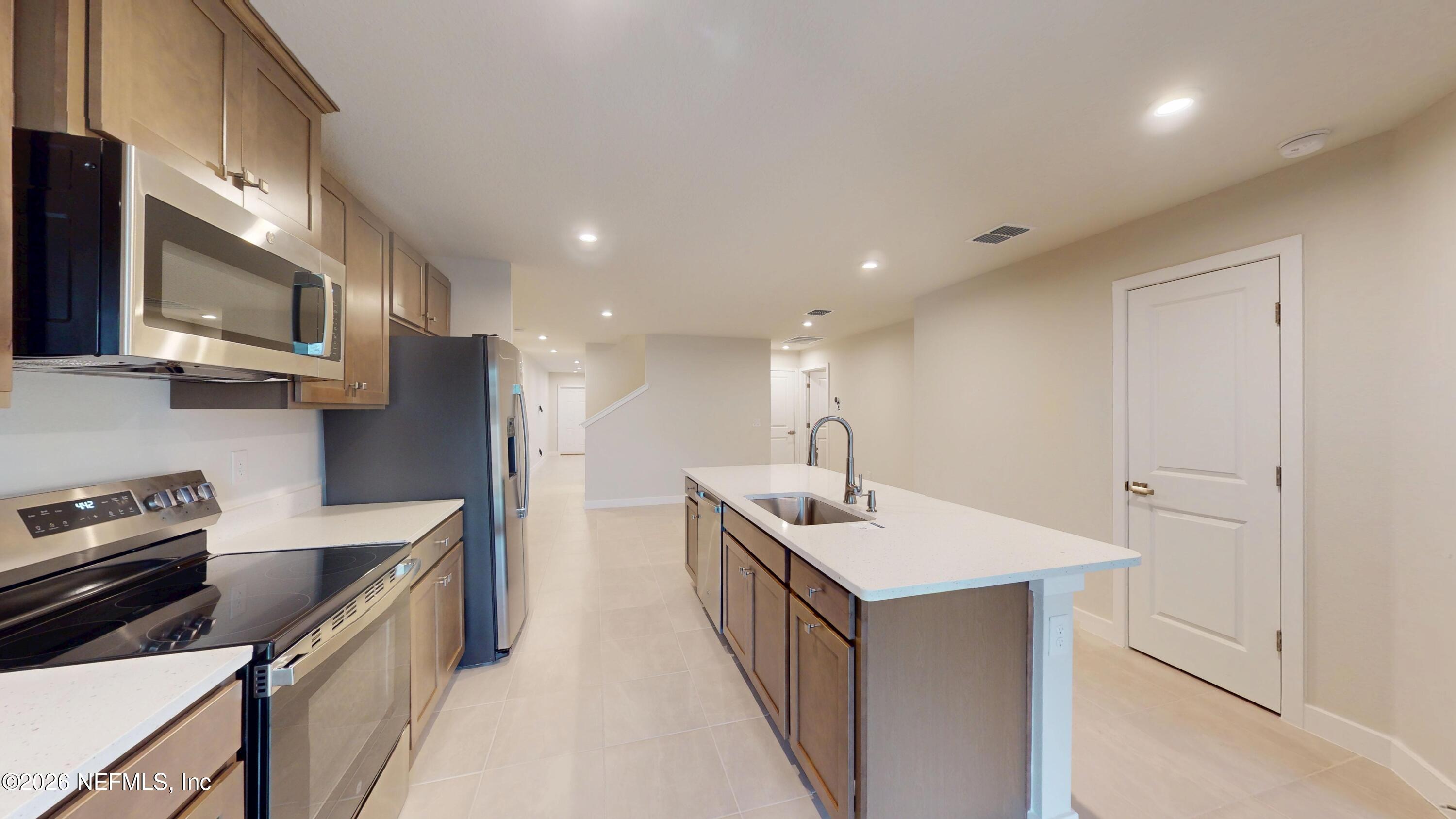 55 Gaston Court St. Augustine, FL 32092 - Photo 15 of 41 a kitchen with stainless steel appliances a sink stove and cabinets