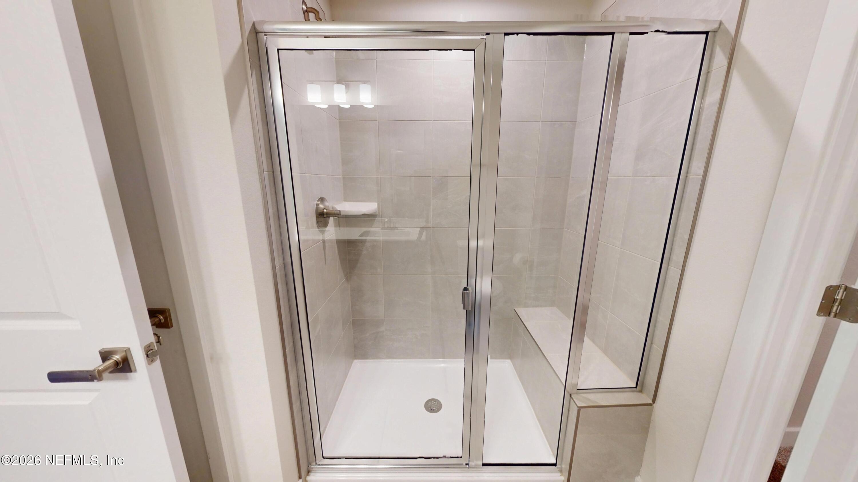 55 Gaston Court St. Augustine, FL 32092 - Photo 19 of 41 a bathroom with a glass shower door