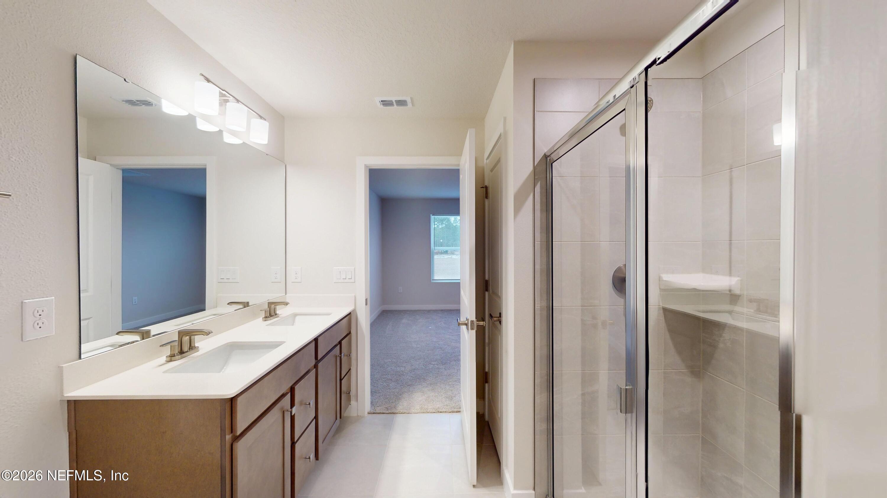 55 Gaston Court St. Augustine, FL 32092 - Photo 21 of 41 a bathroom with a double vanity sink mirror and shower