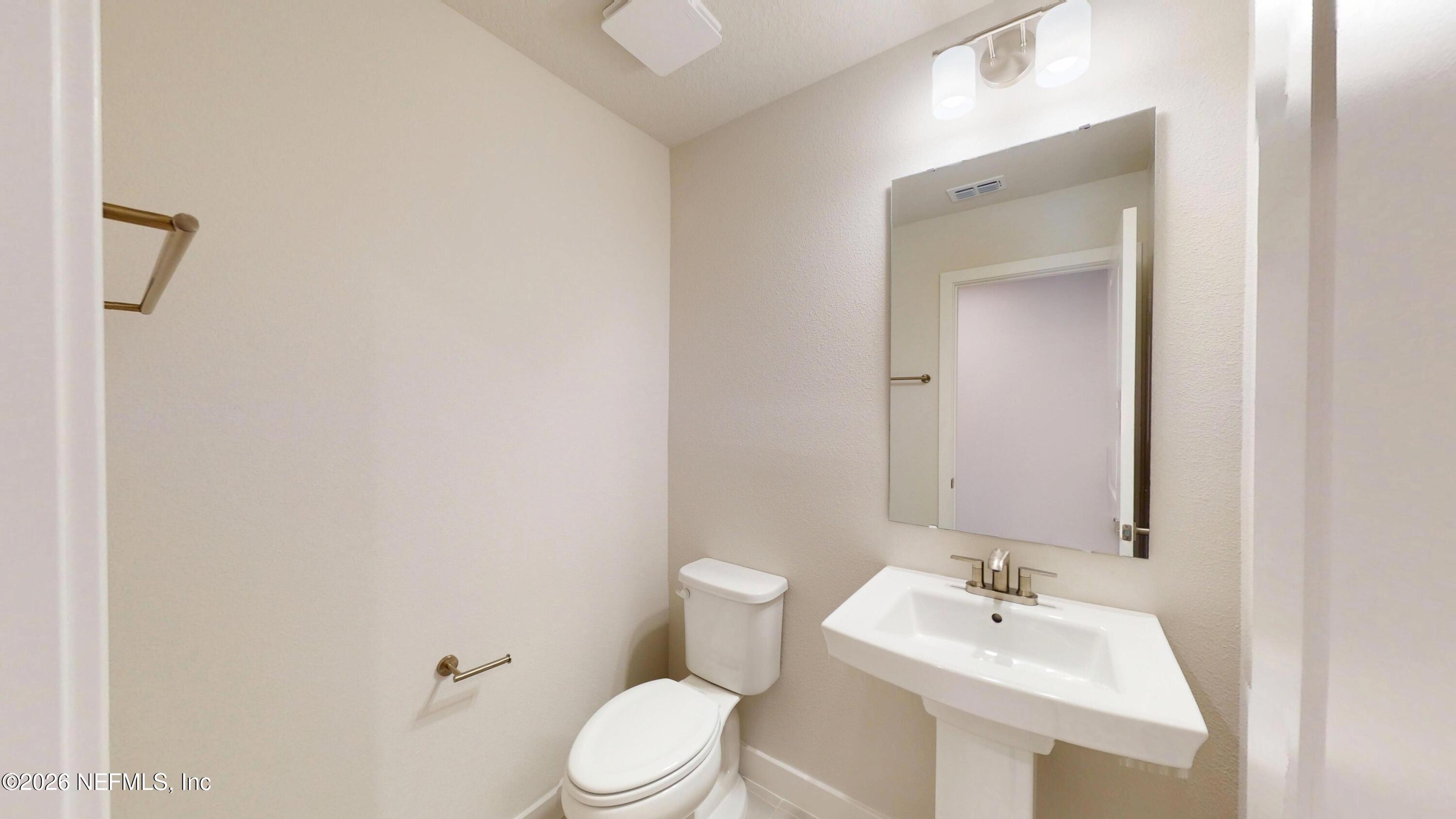 55 Gaston Court St. Augustine, FL 32092 - Photo 5 of 41 a bathroom with a sink a toilet and mirror