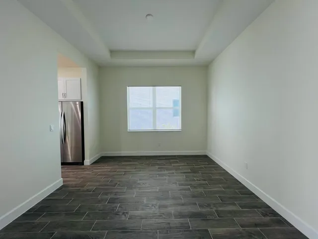 a utility room with granite countertop cabinets sink and stove