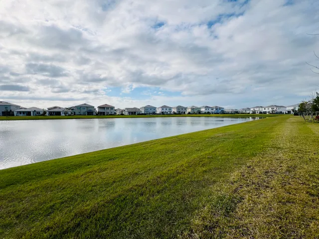 a view of a lake with houses in the back