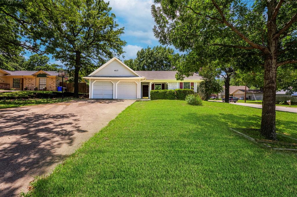 617 Rolling Ridge Court Azle, TX 76020 - Photo 1 of 20 Single-story residence featuring a light-colored exterior and a prominent two-car garage
