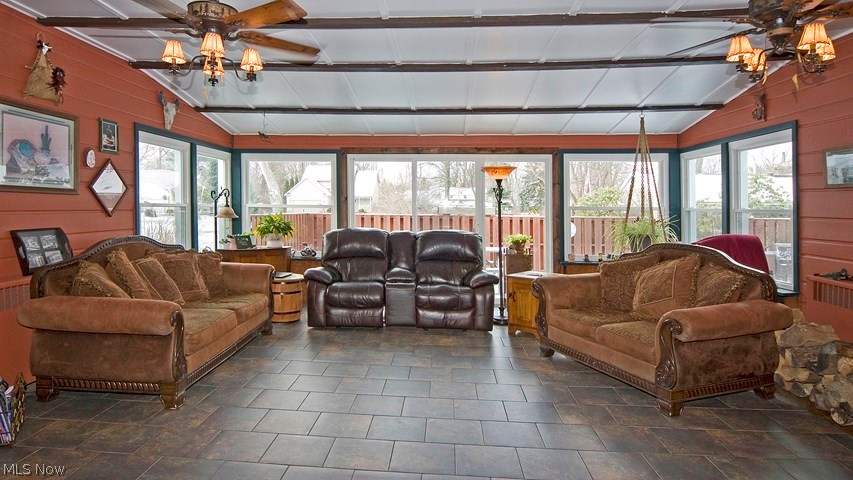 1692 Dunbar Road Madison, OH 44057 - Photo 2 of 9 The large family room includes a wood burning stove, plenty of natural light and views of the backyard and deck.