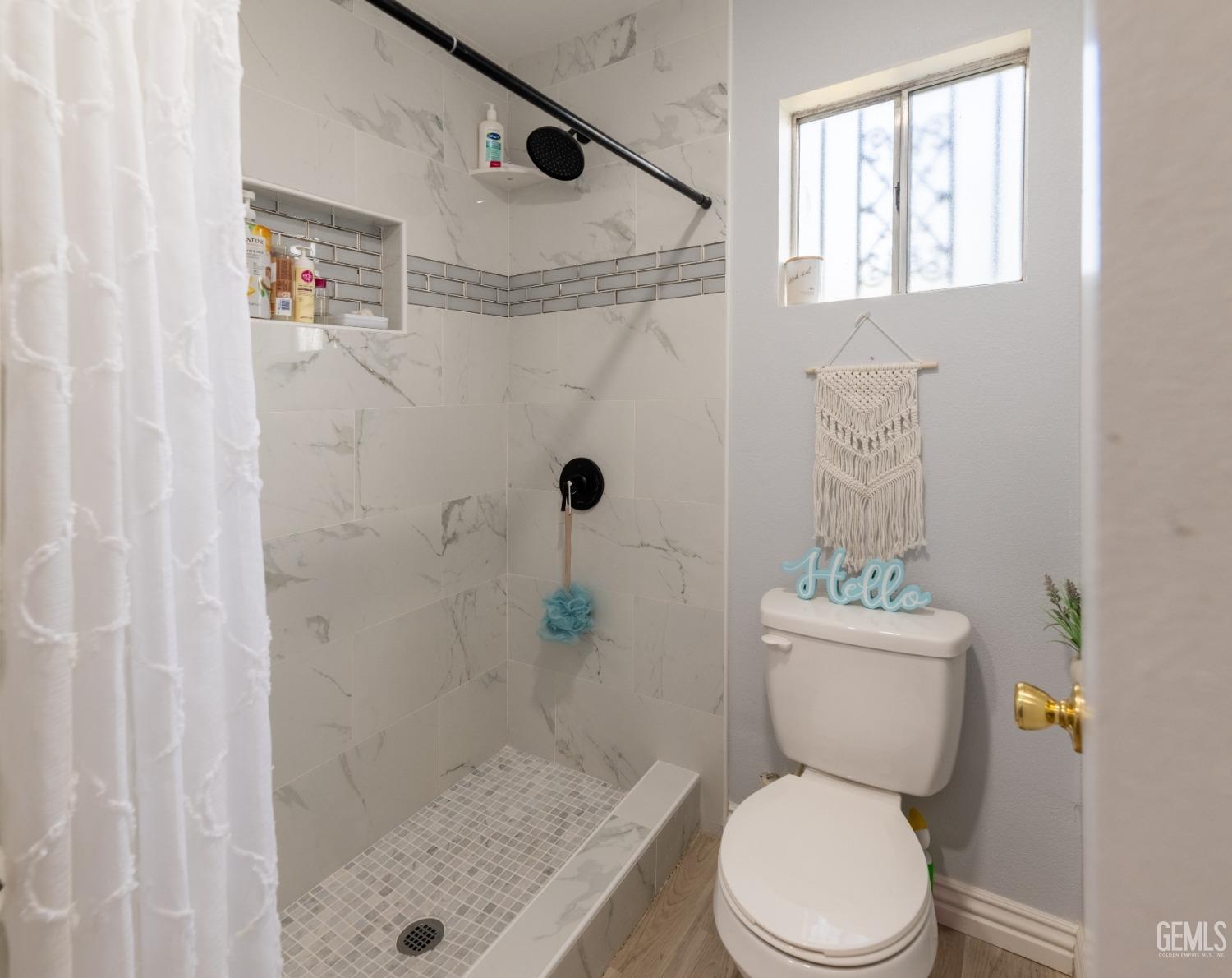 Undisclosed Address Delano, CA 93215 - Photo 11 of 19 a white toilet sitting next to a shower