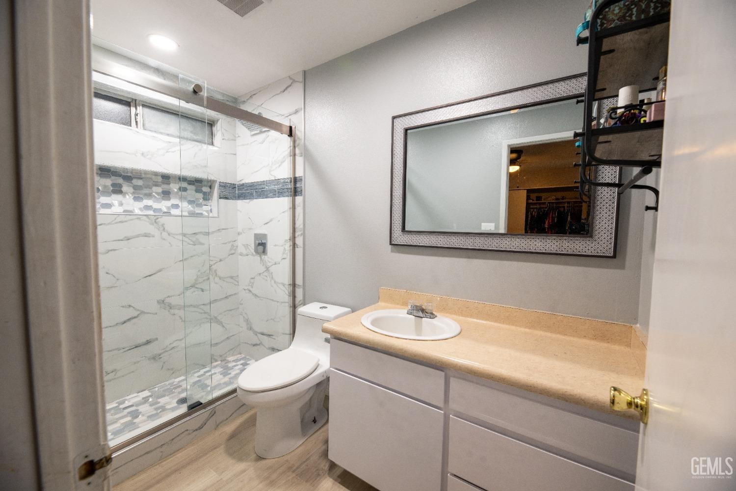 Undisclosed Address Delano, CA 93215 - Photo 13 of 19 a bathroom with a granite countertop sink toilet and shower