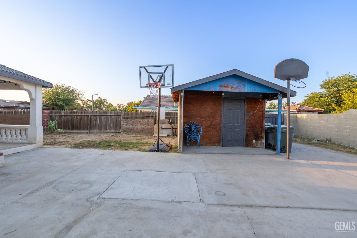 Undisclosed Address Delano, CA 93215 - Photo 15 of 19 a view of a house with backyard and a garage