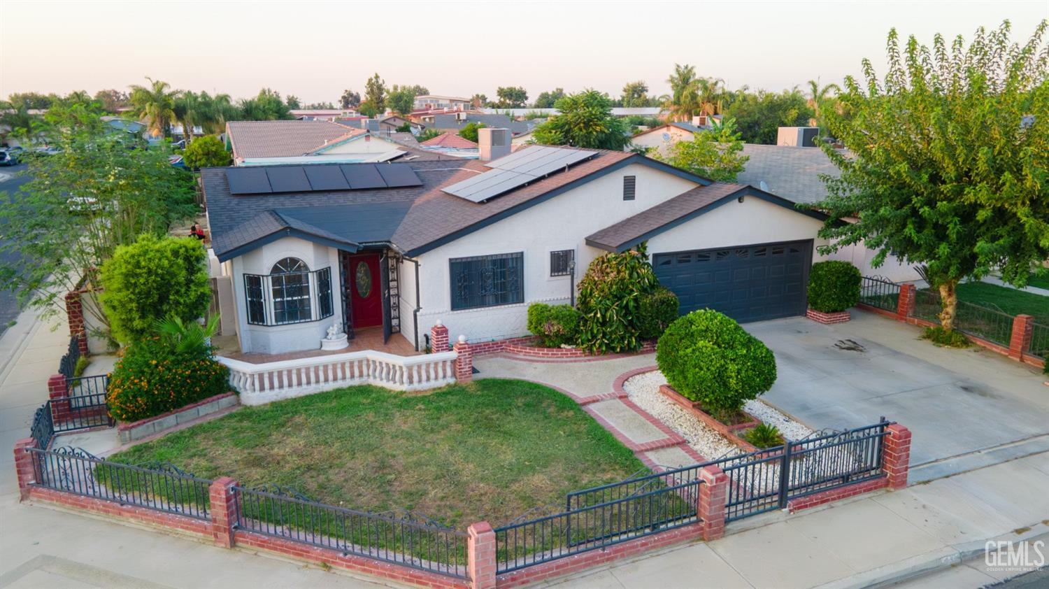 Undisclosed Address Delano, CA 93215 - Photo 17 of 19 a aerial view of a house with table and chairs plants and large tree