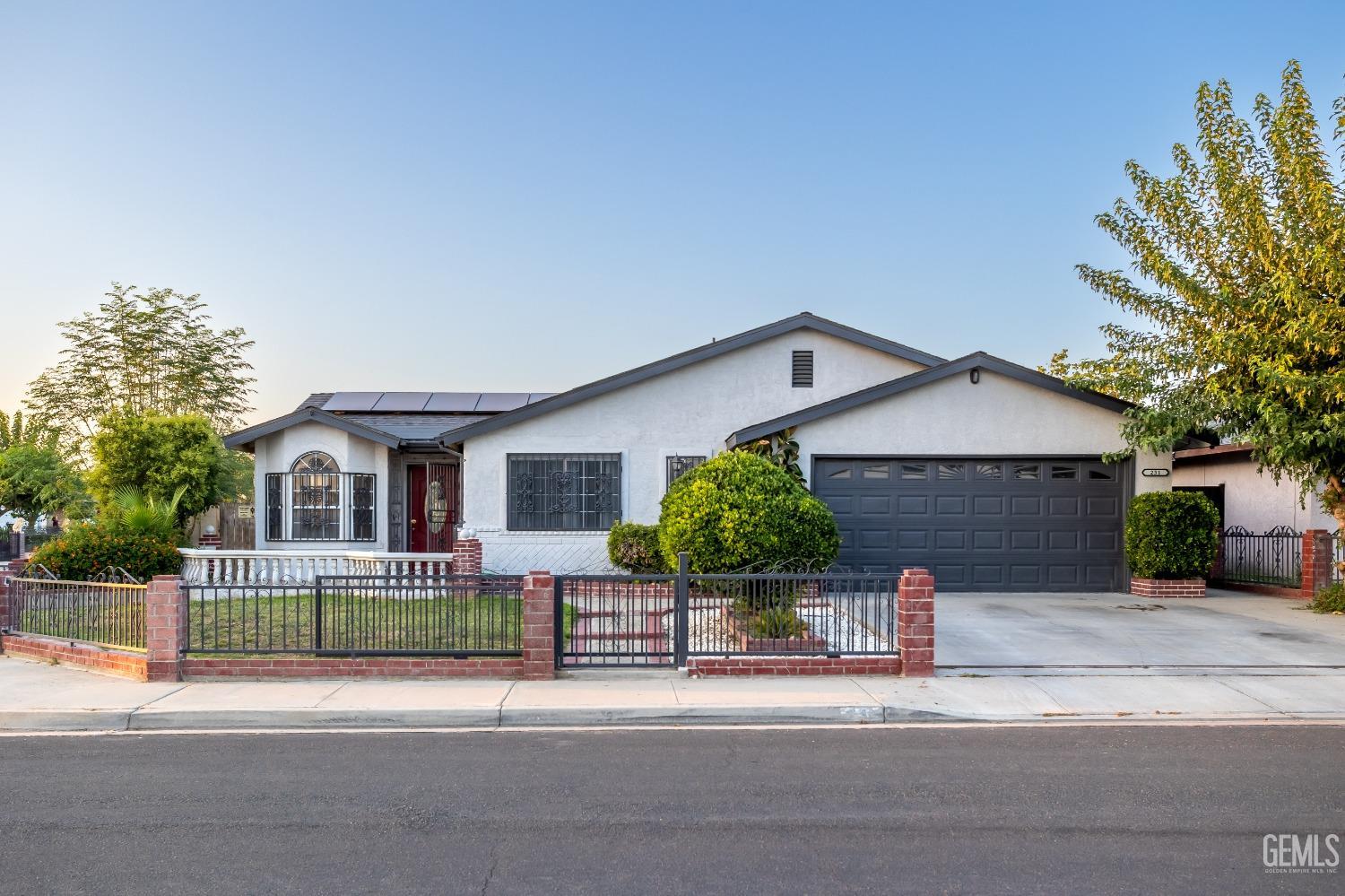 Undisclosed Address Delano, CA 93215 - Photo 2 of 19 a front view of a house with a yard and garage