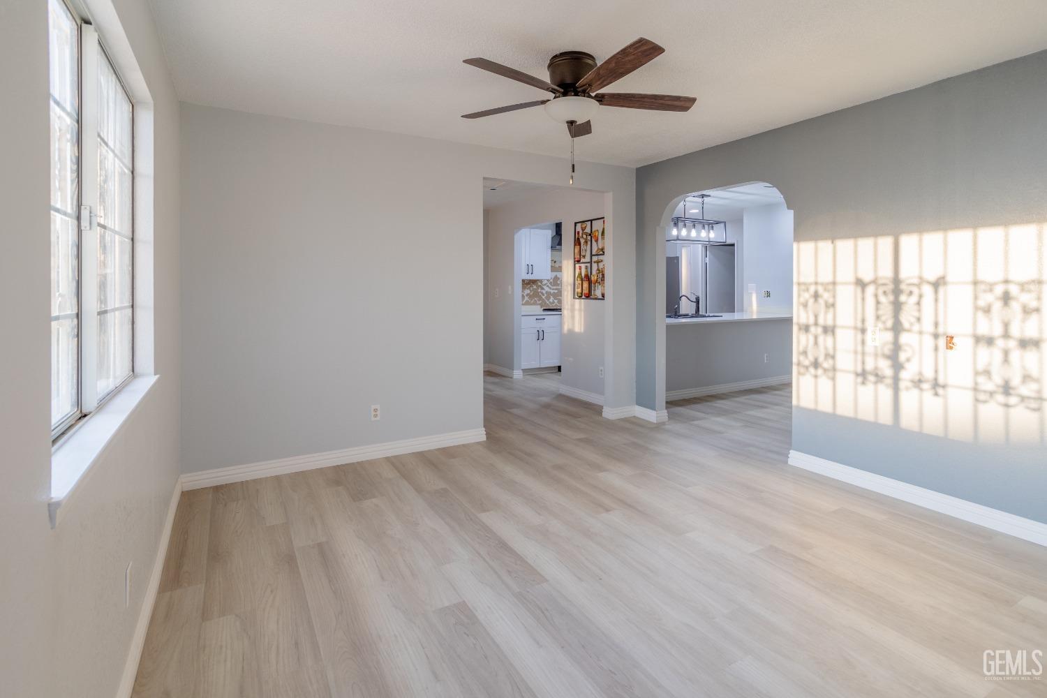 Undisclosed Address Delano, CA 93215 - Photo 4 of 19 wooden floor in an empty room with a window