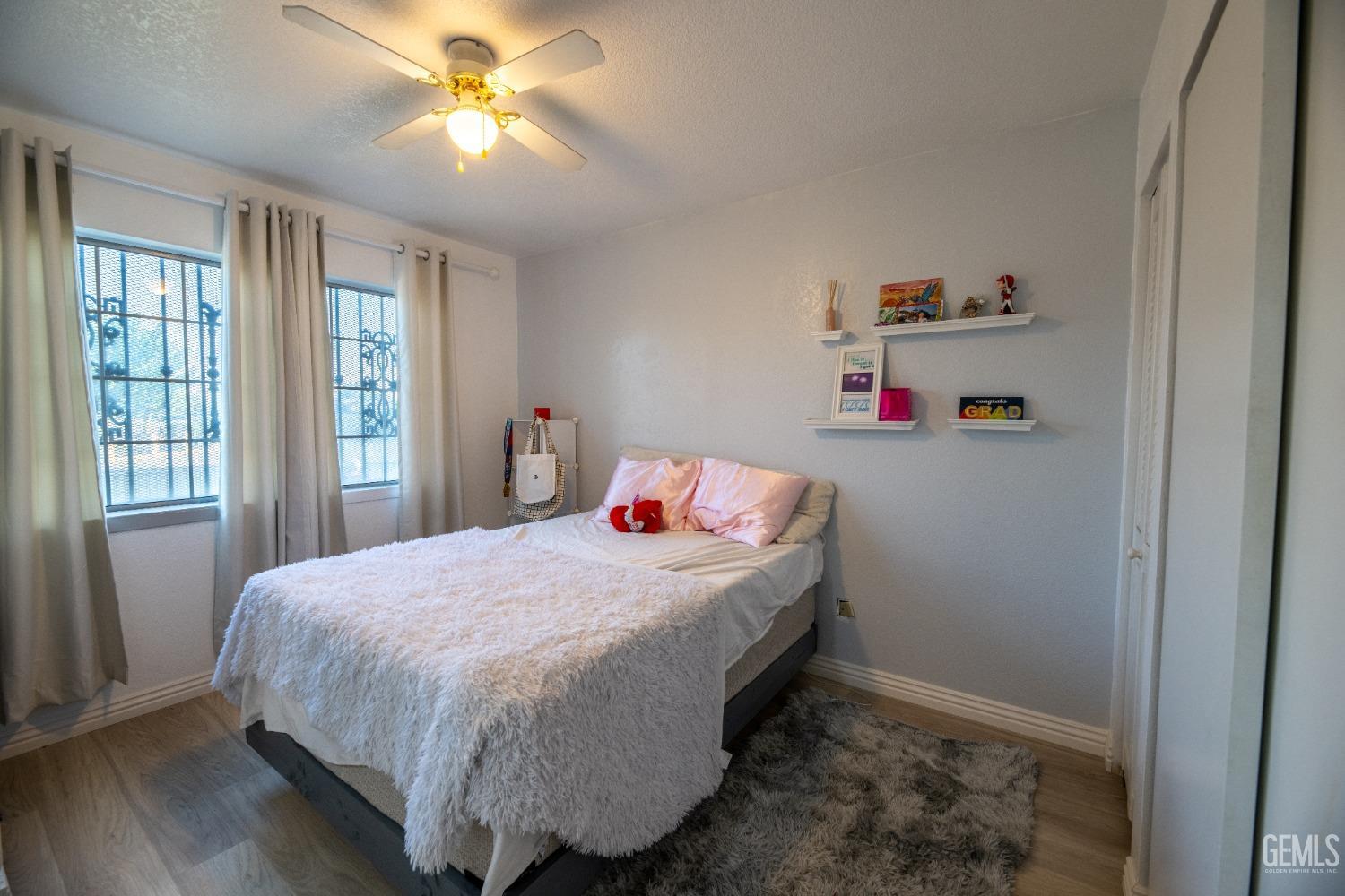 Undisclosed Address Delano, CA 93215 - Photo 8 of 19 a bedroom with a bed and a chandelier