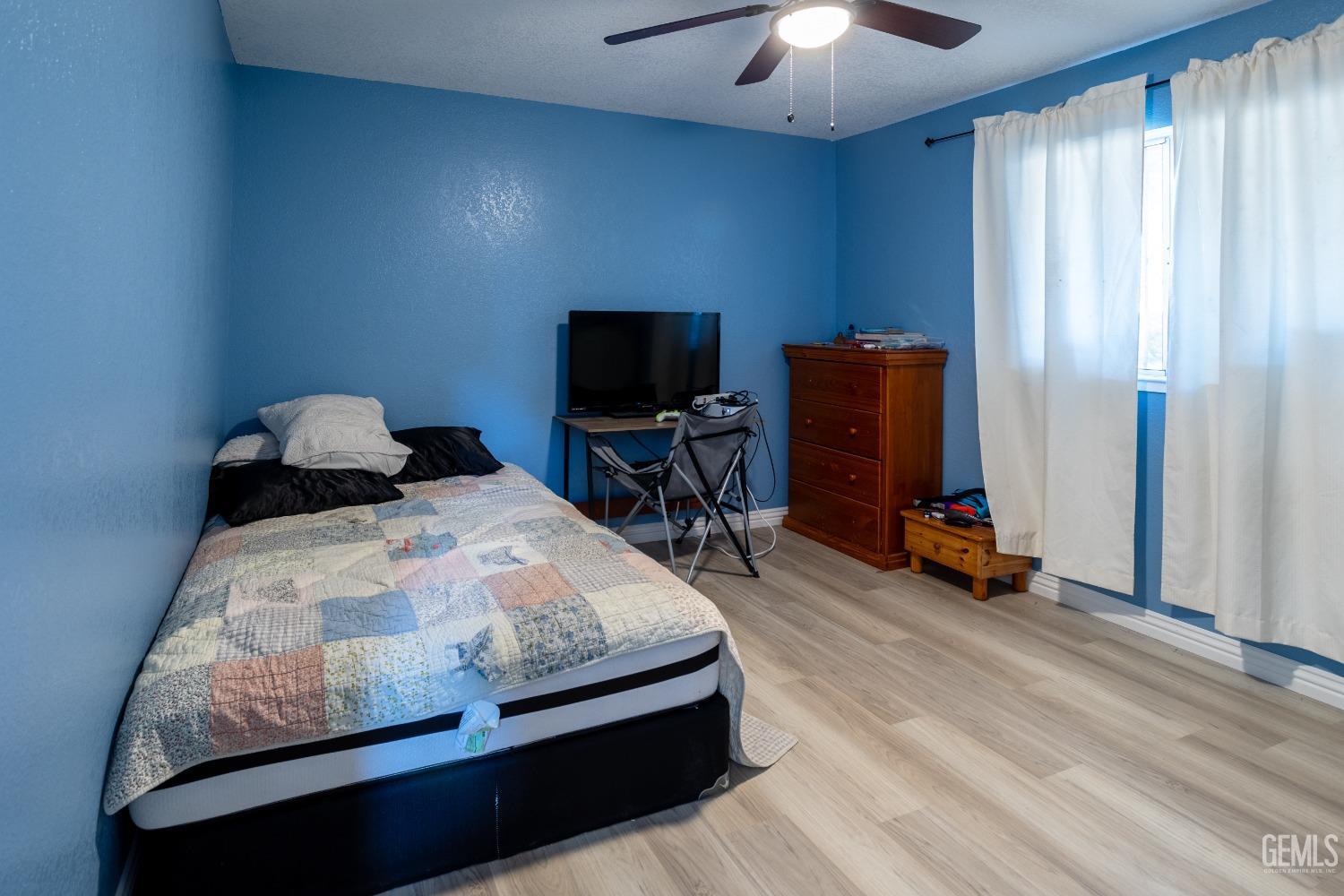 Undisclosed Address Delano, CA 93215 - Photo 9 of 19 a bedroom with bed and tv