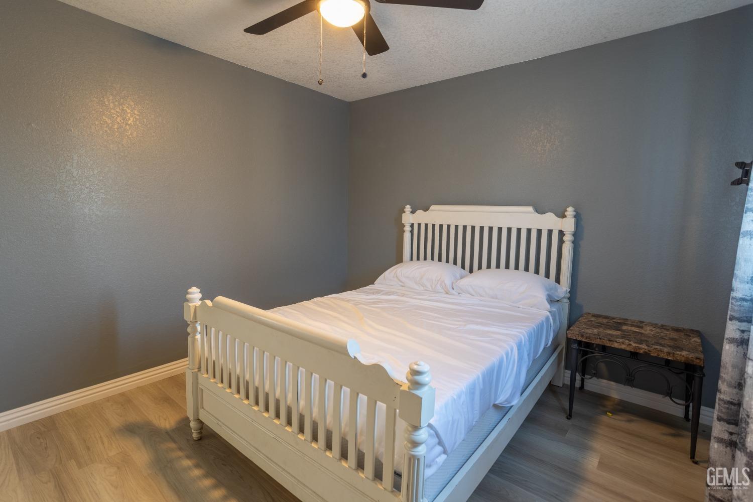 Undisclosed Address Delano, CA 93215 - Photo 10 of 19 a bedroom with a bed and a ceiling fan