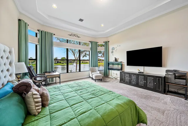 a bedroom with a bed and a flat screen television