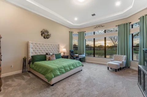 a bedroom with a bed and glass wall painting