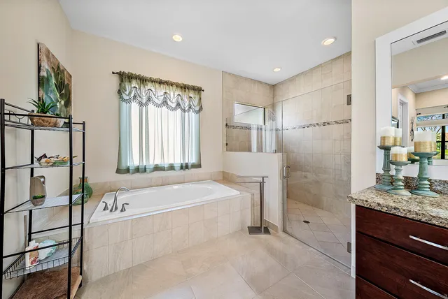 a spacious bathroom with a tub shower and sink