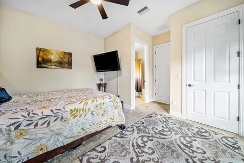 a bedroom with a bed and a television