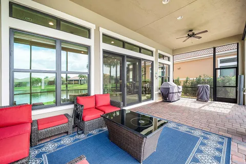 a living room with furniture and a floor to ceiling window