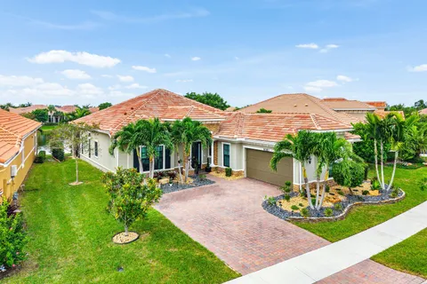 a front view of a house with a garden and patio
