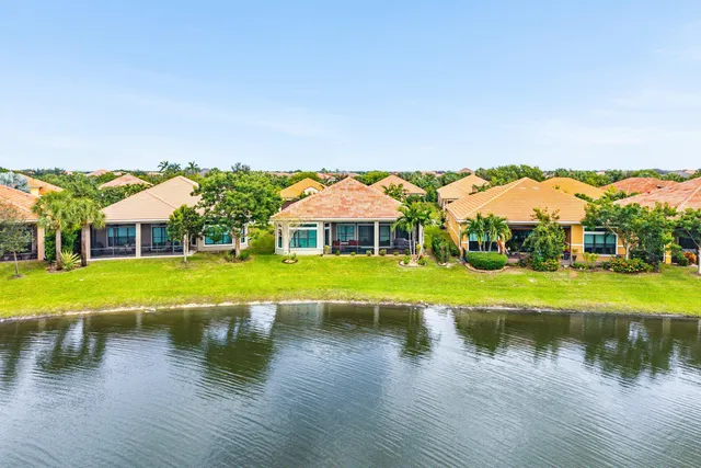 a view of house with garden space and lake view