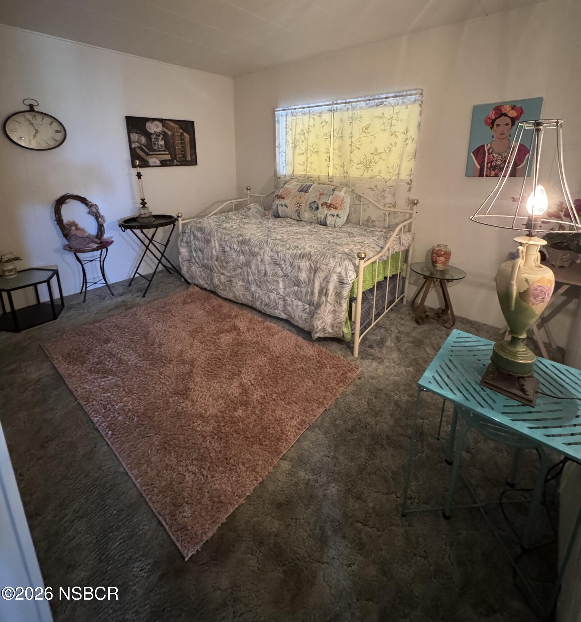3210 Santa Maria Way, Unit 173 Santa Maria, CA 93455 - Photo 12 of 24 a bedroom with a bed a table and chair