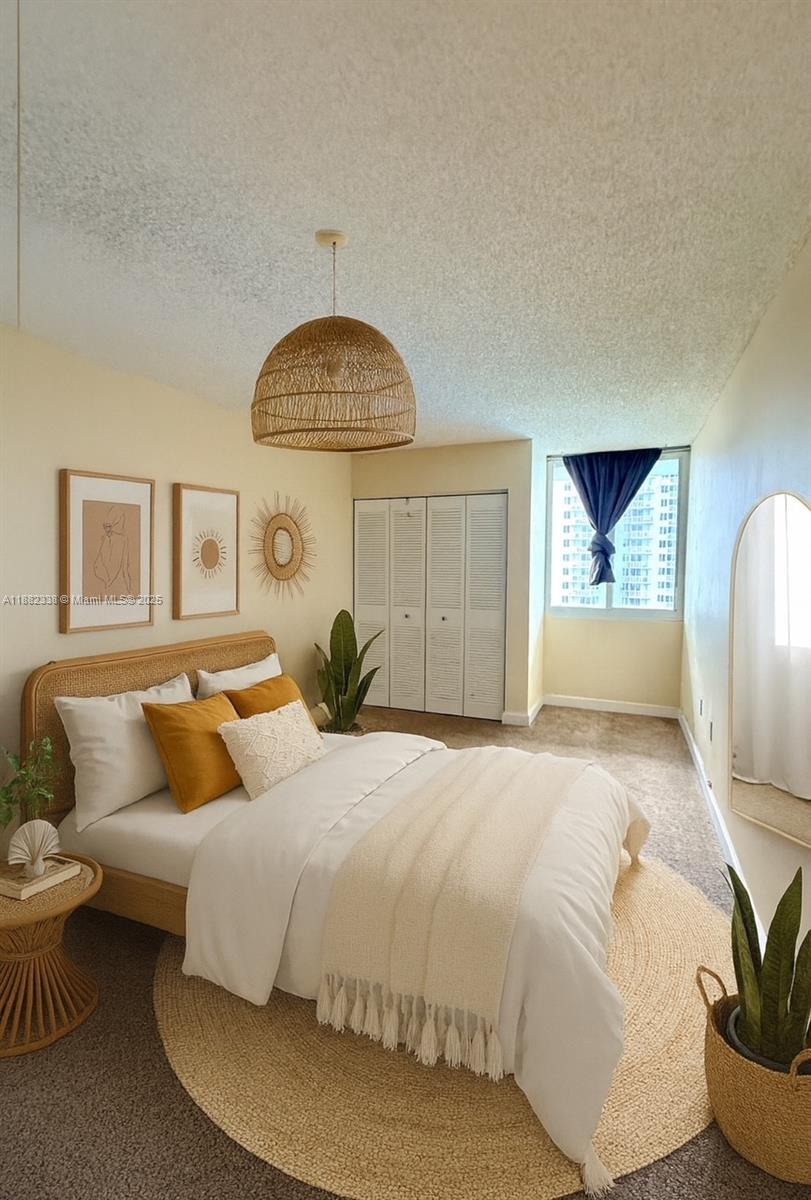 800 North Miami Avenue, Unit E1201 Miami, FL 33136 - Photo 4 of 18 a bedroom with a large bed and a potted plant