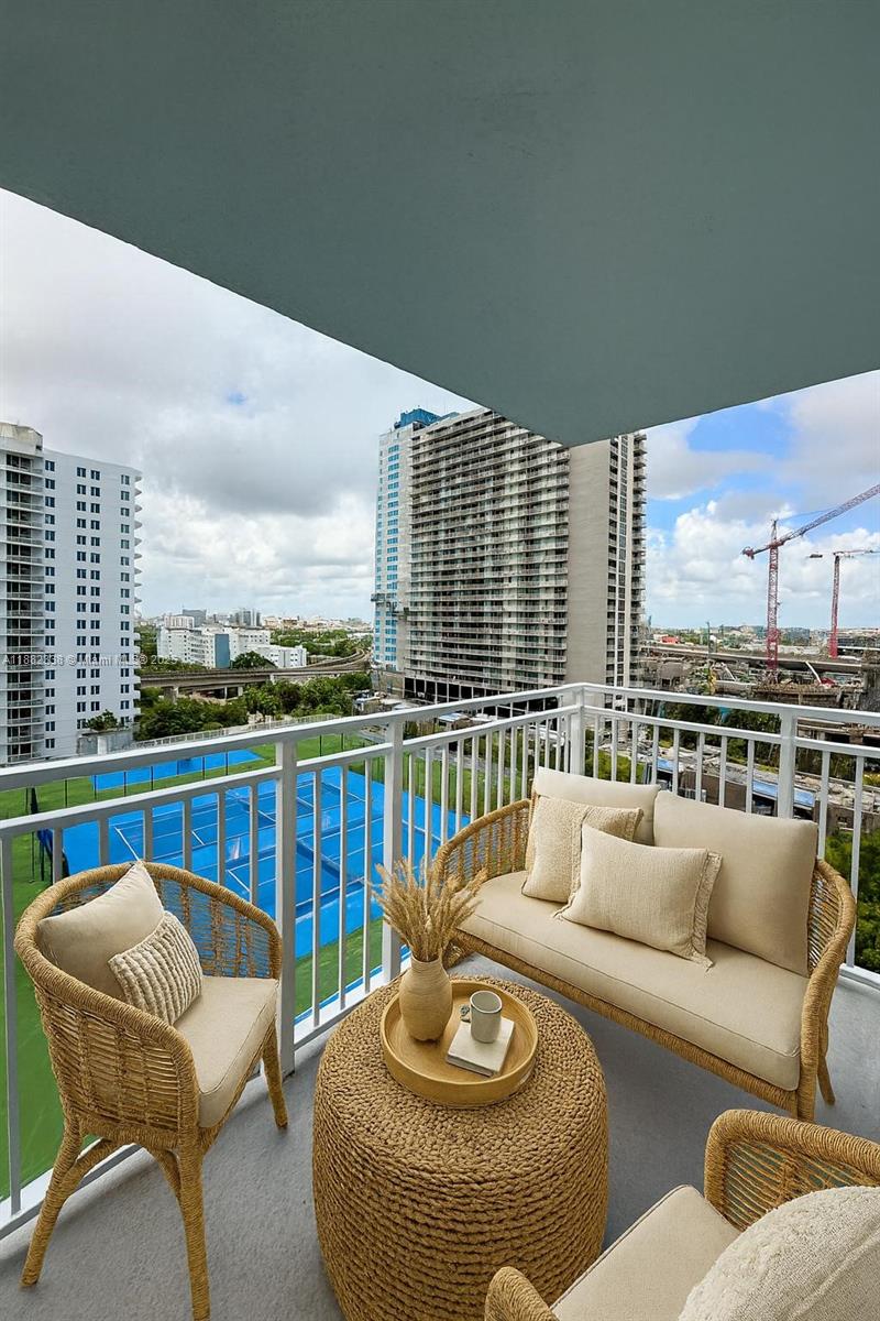 800 North Miami Avenue, Unit E1201 Miami, FL 33136 - Photo 10 of 18 a view of a patio with couches chairs and wooden floor