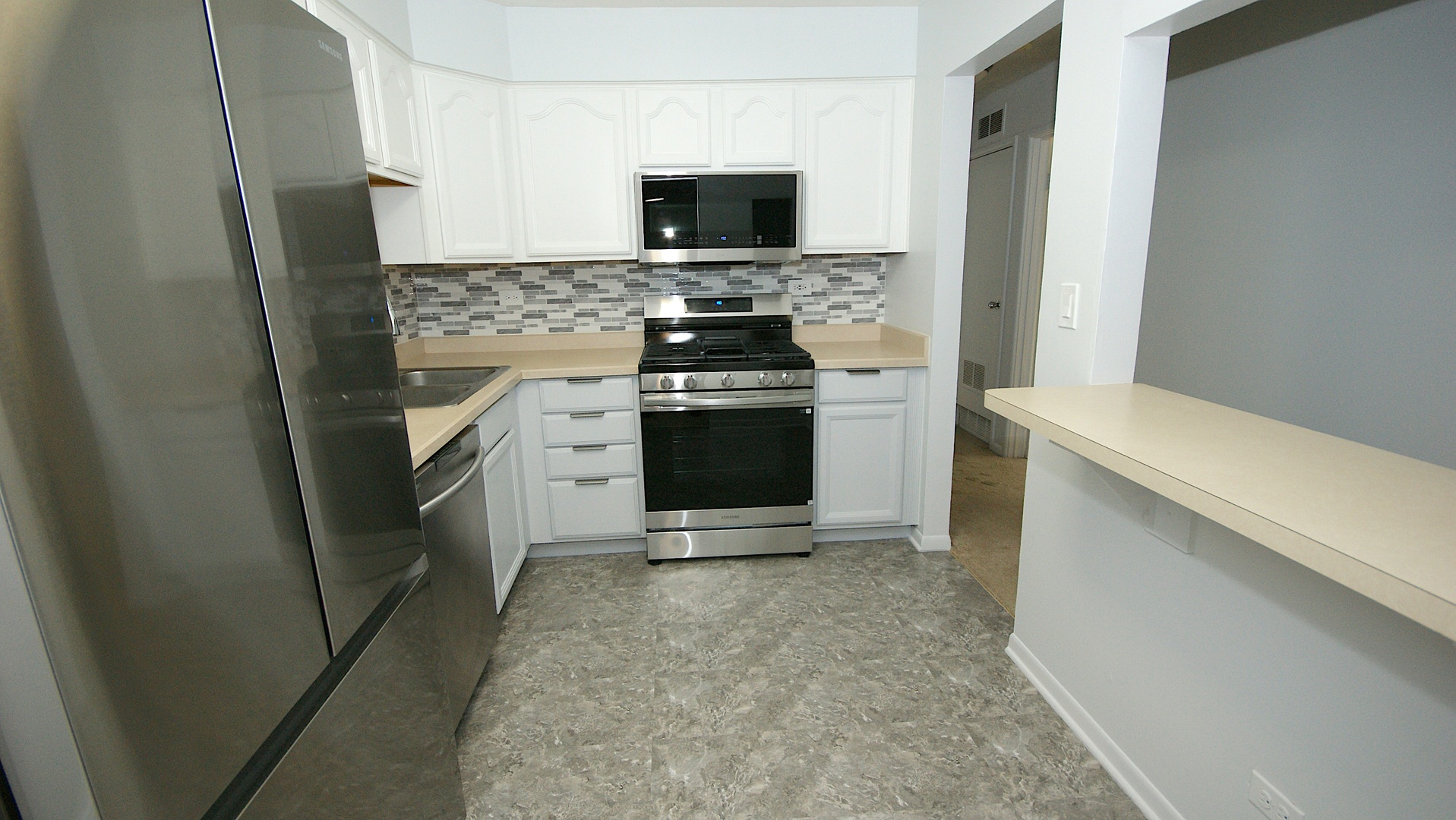 521 73rd Street, Unit 105 Downers Grove, IL 60516 - Photo 8 of 17 a kitchen with a stove and a refrigerator