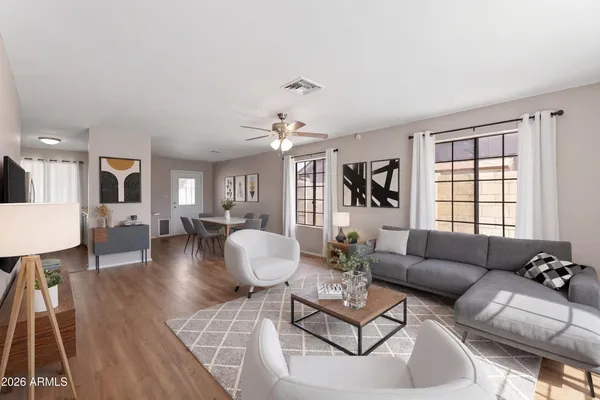 a living room with furniture and wooden floor