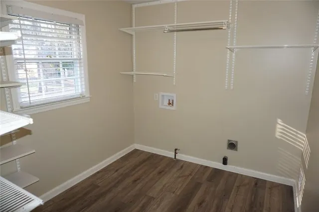 a room with a window and wooden floor