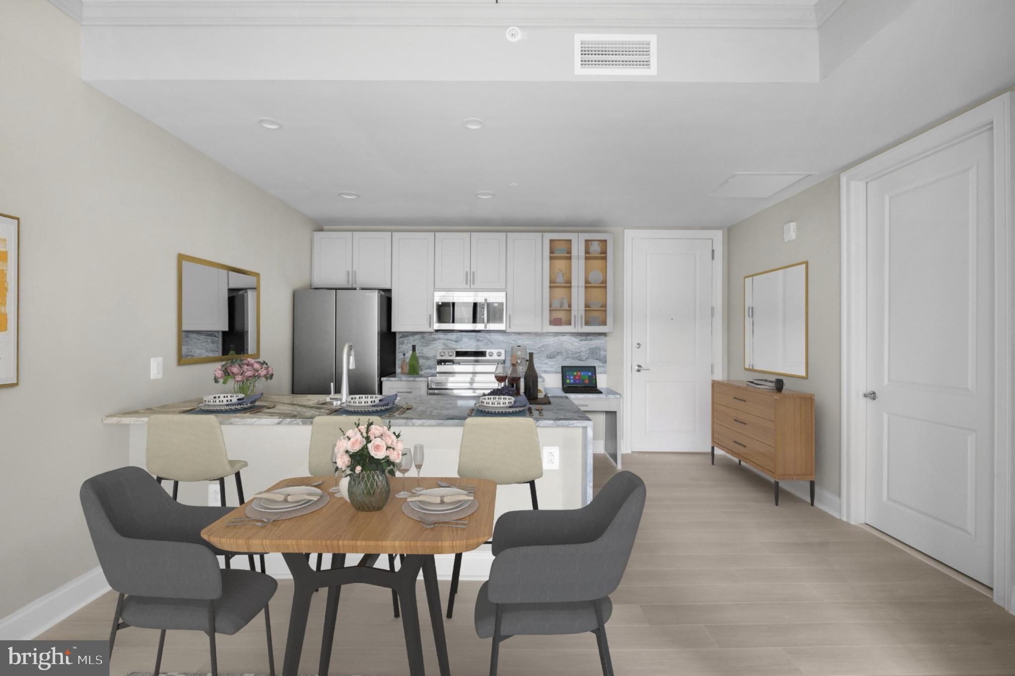 2301-61 John F Kennedy Boulevard, Unit 1902 Philadelphia, PA 19103 - Photo 15 of 39 a dining room with furniture and a kitchen view