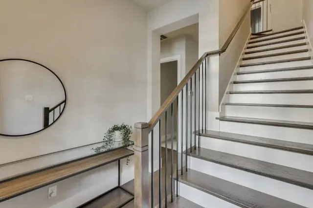 a view of staircase with wooden floor and a potted plant