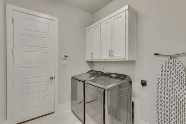 a utility room with cabinets