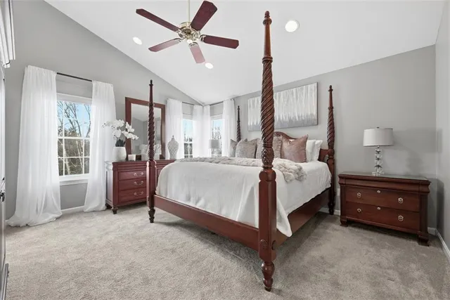 a bedroom with a bed chandelier and a window
