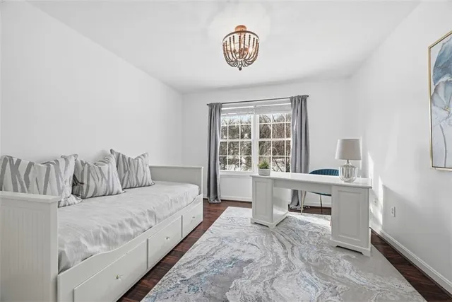 a spacious bedroom with a bed and a table in it