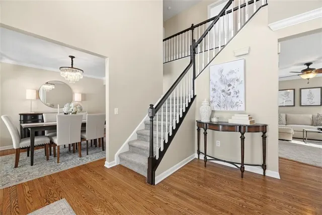 a view of entryway and dining room with wooden floor