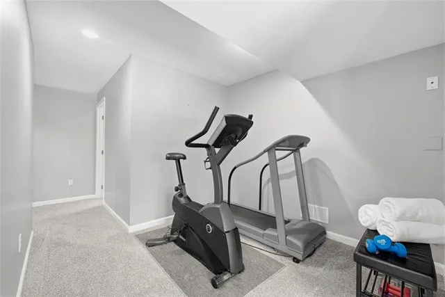 a room with gym equipment and windows