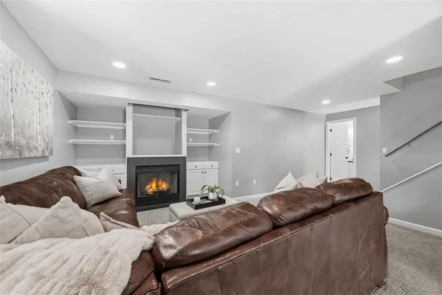 a living room with furniture a fireplace and a fireplace