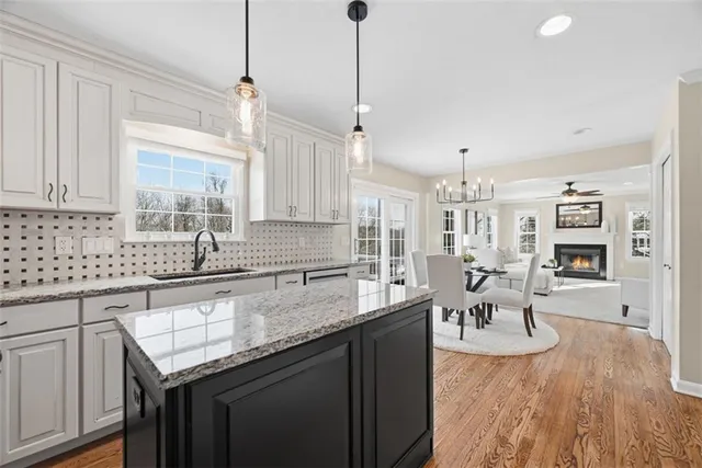 a kitchen with a sink a counter space appliances and cabinets